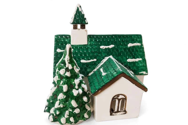 Glazed ceramic Christmas village church with evergreen tree