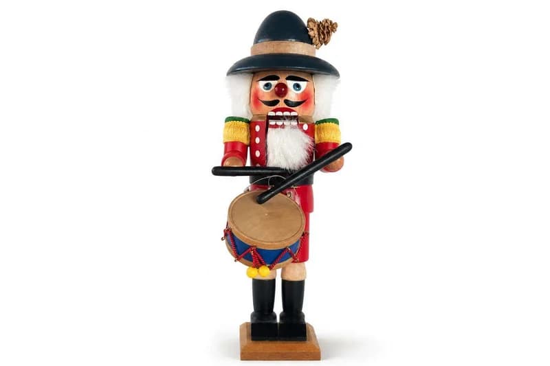 Wooden nutcracker drummer figurine with black hat and red uniform